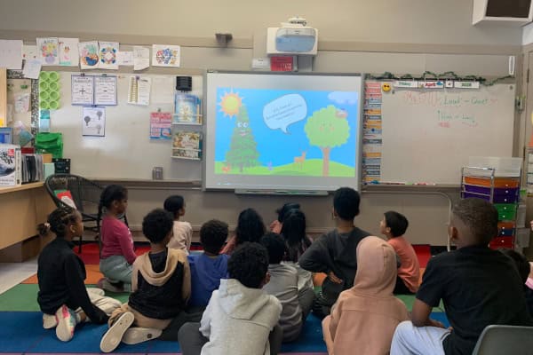 St. Pius X 2b 2025 St Pius X 2B 2025 PIF Project. Children look at a video they created on a large screen
